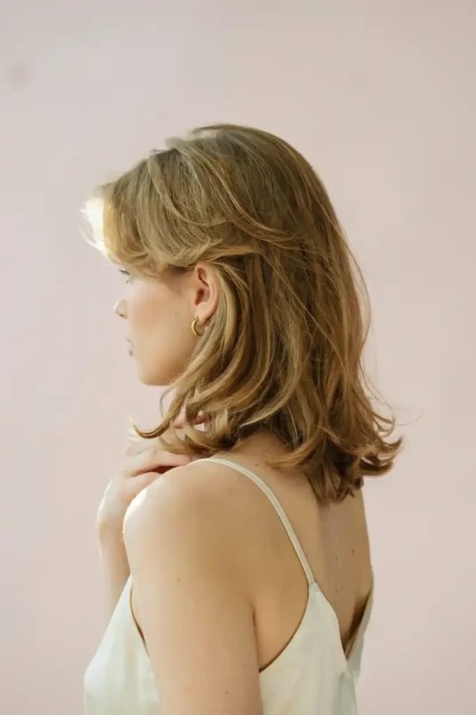 Feathered Shoulder-Length Blowout With Soft Flipped Ends And Volume